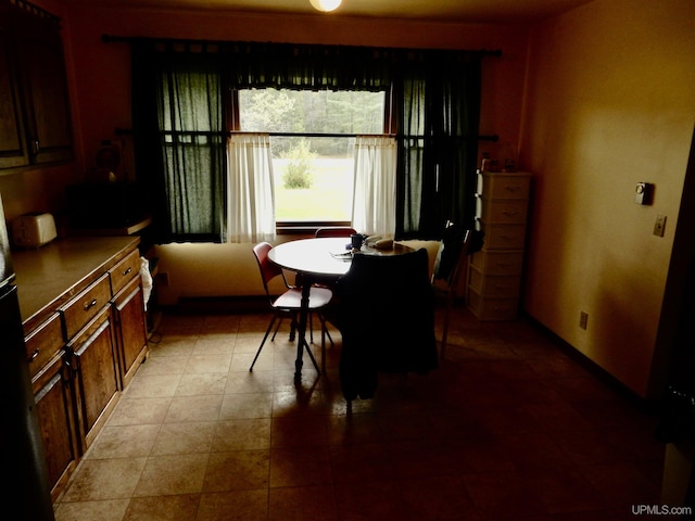 4815 N Southside Rd, Manistique, MI 49854 - dining space featuring baseboards and light tile patterned floors