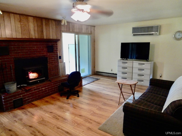 4815 N Southside Rd, Manistique, MI 49854 - living area with a wall mounted air conditioner, a baseboard radiator, light wood-type flooring, ceiling fan, and a fireplace