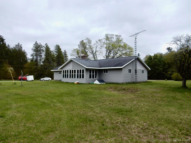 4815 N Southside Rd, Manistique, MI 49854 - rear view of house featuring a lawn and a chimney