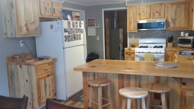 4158 Scott Ct, Gladwin, MI 48624 - kitchen with white appliances, crown molding, a kitchen bar, backsplash, and butcher block counters