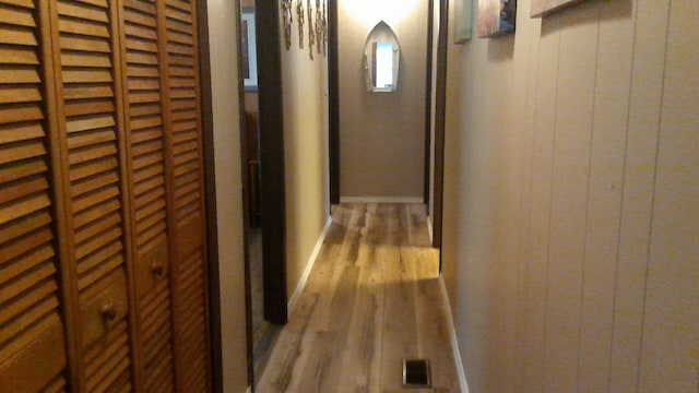 4158 Scott Ct, Gladwin, MI 48624 - hall featuring wood finished floors, wood walls, and baseboards