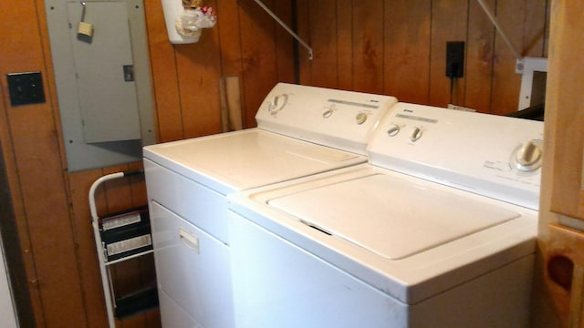 4158 Scott Ct, Gladwin, MI 48624 - washroom with washer and clothes dryer, wooden walls, and electric panel