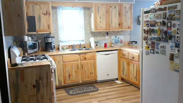 4158 Scott Ct, Gladwin, MI 48624 - kitchen featuring white appliances, a sink, light brown cabinetry, and backsplash