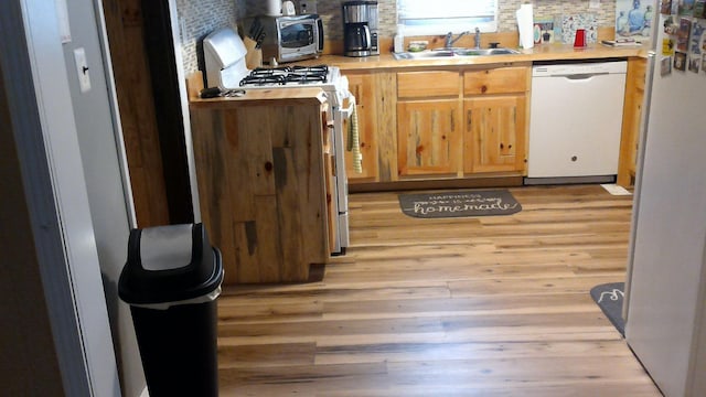 4158 Scott Ct, Gladwin, MI 48624 - kitchen with white appliances, a sink, light countertops, and light wood-style flooring