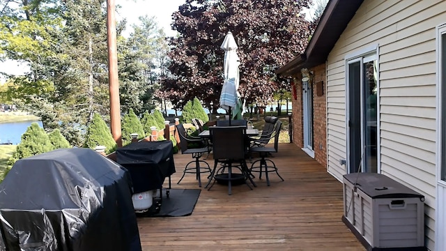 4158 Scott Ct, Gladwin, MI 48624 - wooden terrace with outdoor dining area and grilling area