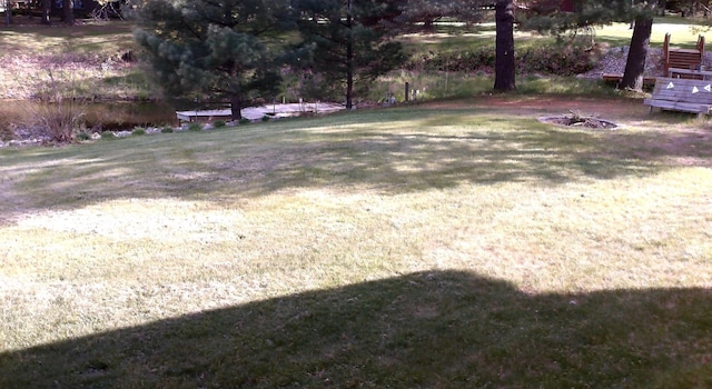 4158 Scott Ct, Gladwin, MI 48624 - view of grassy yard with a fire pit