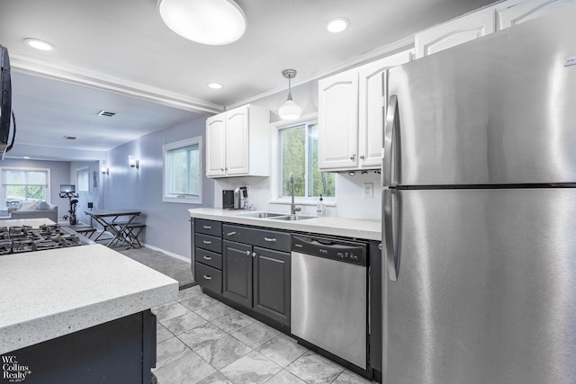 656 Lawson Dr, Lake Orion, MI 48362 - kitchen featuring stainless steel appliances, a sink, white cabinetry, light marble finish floors, and plenty of natural light