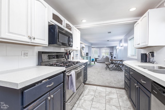 656 Lawson Dr, Lake Orion, MI 48362 - kitchen with stainless steel appliances, light carpet, white cabinets, a sink, and open floor plan