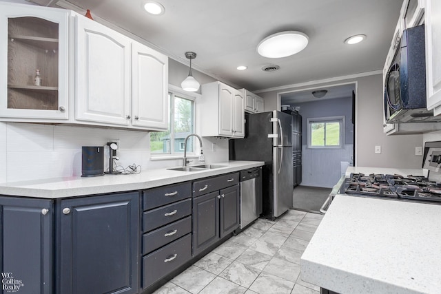 656 Lawson Dr, Lake Orion, MI 48362 - kitchen featuring stainless steel appliances, a sink, white cabinets, ornamental molding, and light countertops