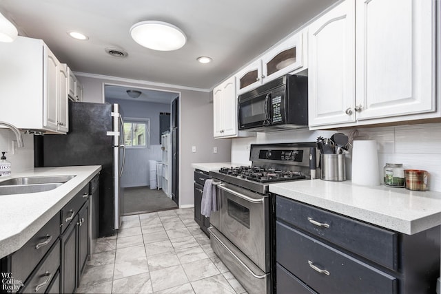 656 Lawson Dr, Lake Orion, MI 48362 - kitchen with appliances with stainless steel finishes, a sink, white cabinetry, light marble finish flooring, and light countertops