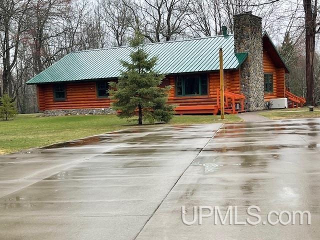 2051 Town Rd M Rd, Florence T-Wi, WI 54121 - cabin with a chimney, metal roof, concrete driveway, log siding, and a front lawn