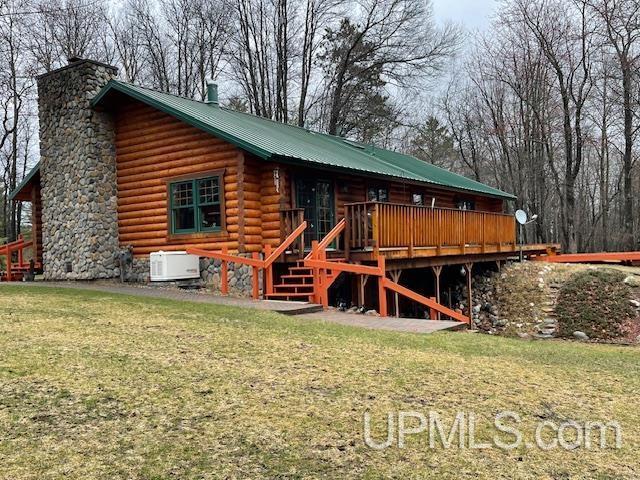 2051 Town Rd M Rd, Florence T-Wi, WI 54121 - view of side of property featuring a chimney, log siding, a lawn, a deck, and metal roof