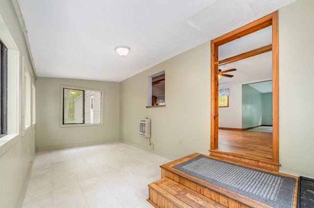 122 Shady Grove Ln, Roscommon, MI 48653 - spare room with heating unit, baseboards, and ceiling fan