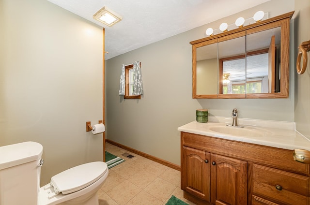 122 Shady Grove Ln, Roscommon, MI 48653 - bathroom featuring toilet, vanity, and baseboards