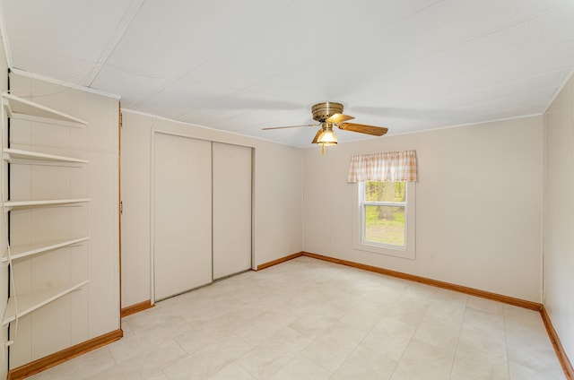 122 Shady Grove Ln, Roscommon, MI 48653 - unfurnished bedroom with baseboards, a closet, and a ceiling fan