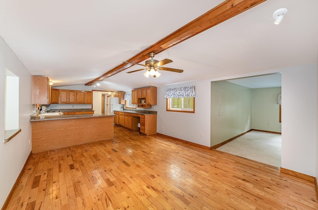 122 Shady Grove Ln, Roscommon, MI 48653 - kitchen with light wood-type flooring, a peninsula, brown cabinetry, ceiling fan, and baseboards