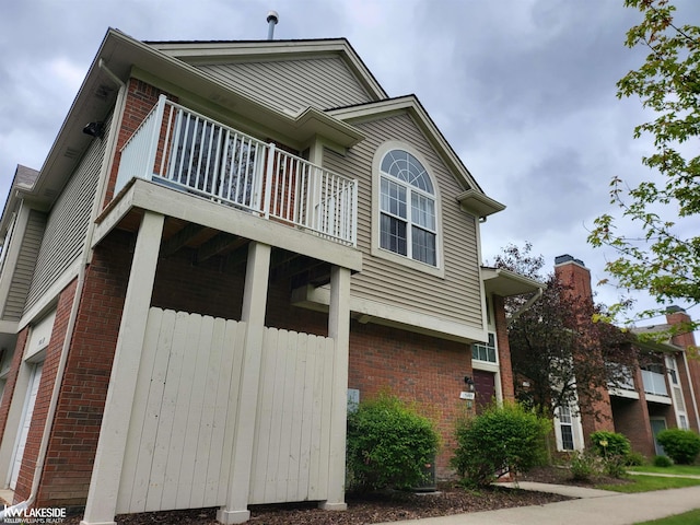15495 Cornell Dr, Clinton Township, MI 48038 - view of home's exterior featuring brick siding and a balcony