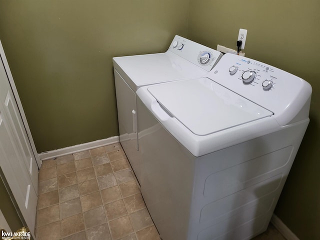 15495 Cornell Dr, Clinton Township, MI 48038 - washroom featuring washing machine and dryer, baseboards, and stone finish flooring