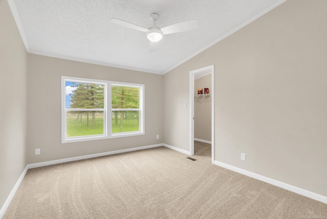 2100 Rowe Rd, Applegate, MI 48401 - carpeted empty room featuring crown molding, lofted ceiling, a textured ceiling, a ceiling fan, and baseboards