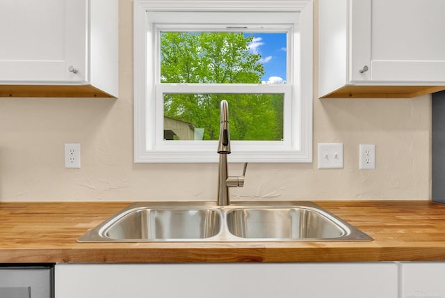2100 Rowe Rd, Applegate, MI 48401 - kitchen view of a sink, wooden counters, and white cabinets