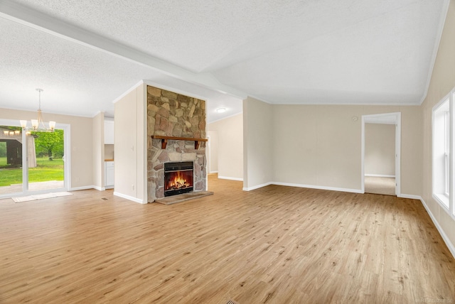 2100 Rowe Rd, Applegate, MI 48401 - unfurnished living room with vaulted ceiling, light wood-style floors, a chandelier, a stone fireplace, and baseboards