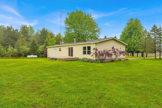 2100 Rowe Rd, Applegate, MI 48401 - rear view of property with a deck and a lawn