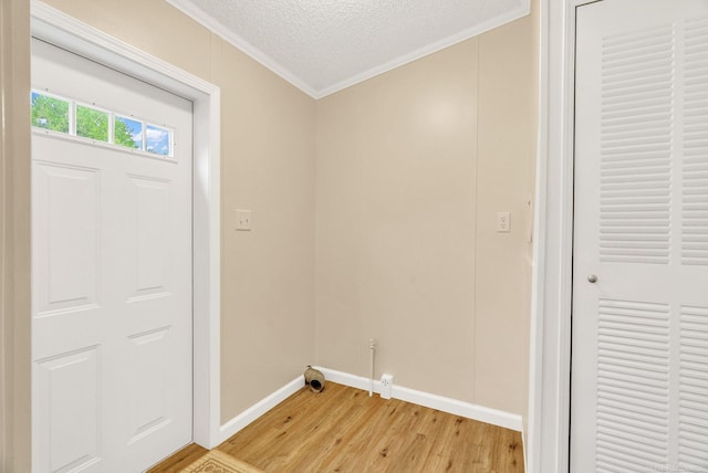 2100 Rowe Rd, Applegate, MI 48401 - washroom with crown molding, light wood-style flooring, baseboards, and a textured ceiling