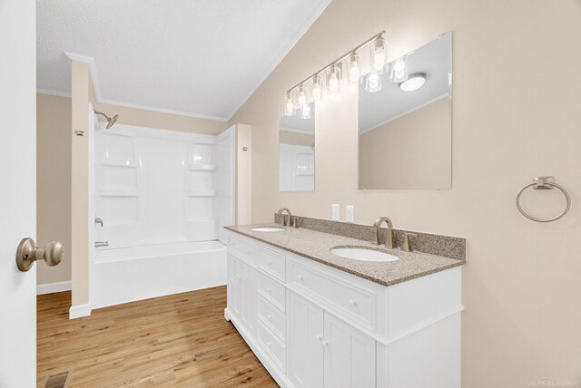 2100 Rowe Rd, Applegate, MI 48401 - bathroom with ornamental molding, double vanity, wood finished floors, and shower / tub combination