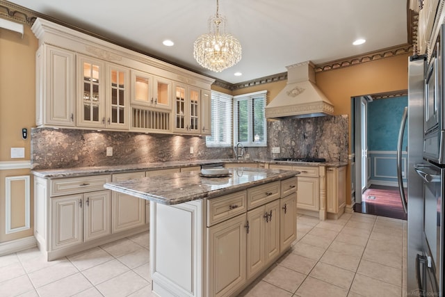 4931 Peggy St, West Bloomfield, MI 48322 - kitchen with premium range hood, cream cabinets, light tile patterned floors, a wainscoted wall, and a decorative wall
