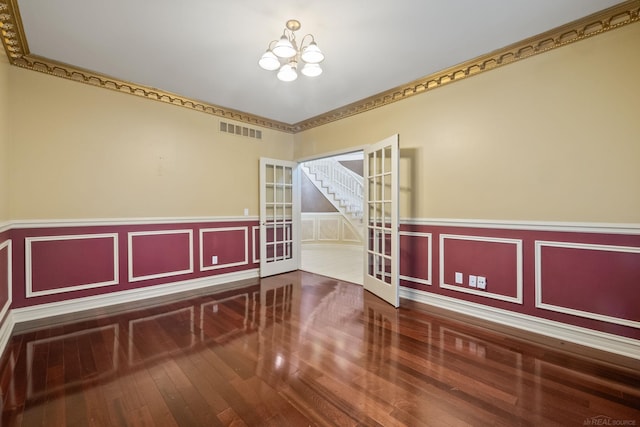4931 Peggy St, West Bloomfield, MI 48322 - unfurnished room featuring a chandelier, hardwood / wood-style flooring, wainscoting, and french doors