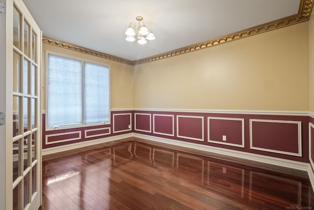 4931 Peggy St, West Bloomfield, MI 48322 - unfurnished room featuring a chandelier, wood finished floors, and a wainscoted wall