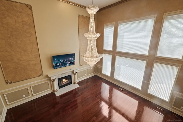 4931 Peggy St, West Bloomfield, MI 48322 - unfurnished living room with a chandelier, a decorative wall, dark wood finished floors, and a fireplace with flush hearth