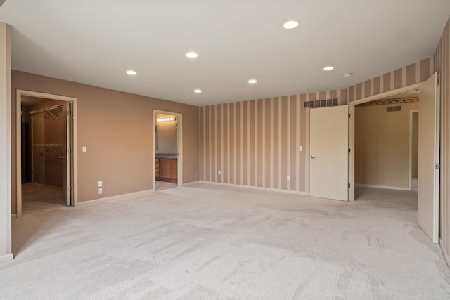 4931 Peggy St, West Bloomfield, MI 48322 - unfurnished bedroom with a spacious closet, recessed lighting, light carpet, baseboards, and ensuite bath
