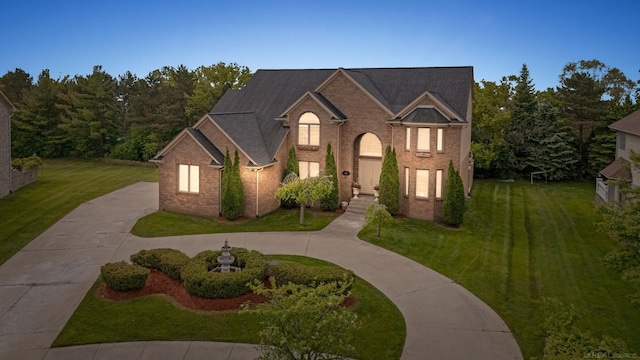 4931 Peggy St, West Bloomfield, MI 48322 - traditional home featuring a front lawn, curved driveway, and brick siding