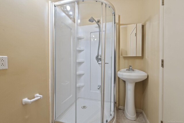 4931 Peggy St, West Bloomfield, MI 48322 - full bathroom with a shower stall, tile patterned floors, baseboards, and a sink