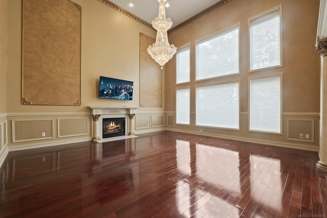 4931 Peggy St, West Bloomfield, MI 48322 - unfurnished living room with a decorative wall, a chandelier, a fireplace with flush hearth, hardwood / wood-style flooring, and a wainscoted wall