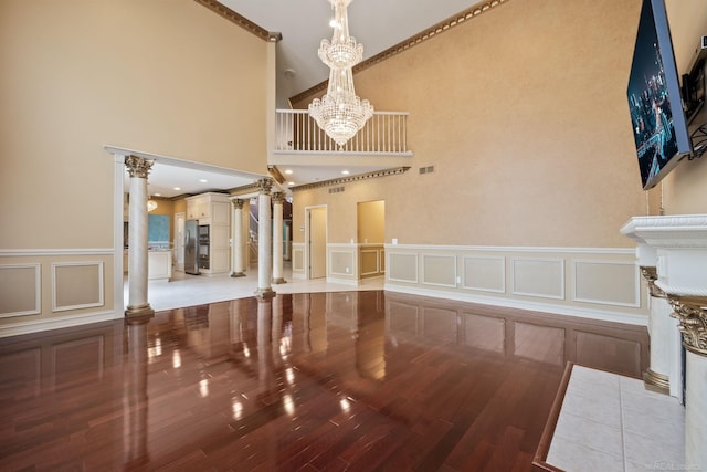 4931 Peggy St, West Bloomfield, MI 48322 - interior space featuring ornate columns, a decorative wall, fridge, wood finished floors, and a wainscoted wall