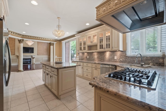 4931 Peggy St, West Bloomfield, MI 48322 - kitchen with cream cabinets, appliances with stainless steel finishes, a sink, a fireplace, and premium range hood