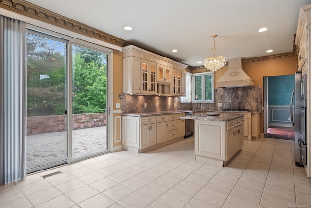 4931 Peggy St, West Bloomfield, MI 48322 - kitchen with premium range hood, cream cabinetry, stainless steel dishwasher, a sink, and backsplash