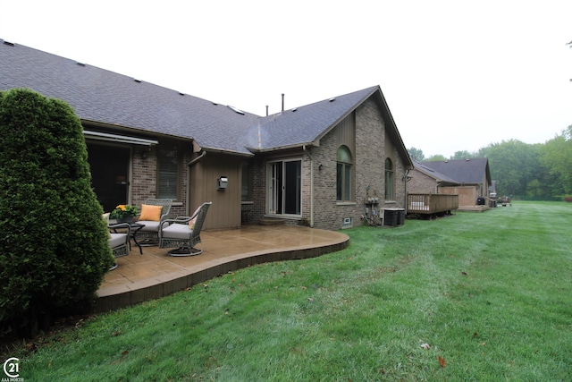 50887 Nature Dr, New Baltimore, MI 48047 - back of house featuring brick siding, a lawn, and a patio
