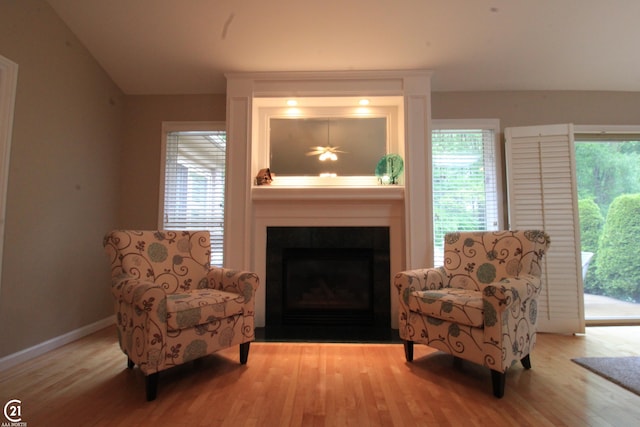50887 Nature Dr, New Baltimore, MI 48047 - living area with wood finished floors, a large fireplace, baseboards, and lofted ceiling