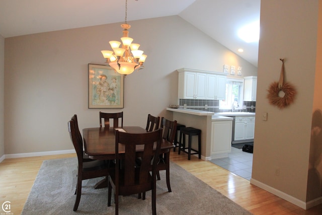 50887 Nature Dr, New Baltimore, MI 48047 - dining room with a chandelier, light wood-type flooring, baseboards, and high vaulted ceiling
