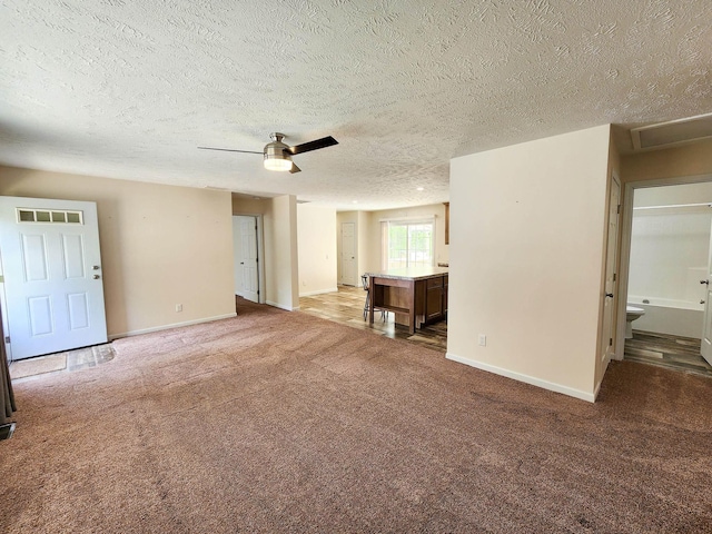 2521 Bonnie Mae Rd, Harrison, MI 48625 - unfurnished living room with a textured ceiling, baseboards, carpet floors, and ceiling fan