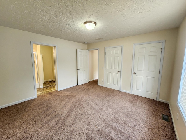 2521 Bonnie Mae Rd, Harrison, MI 48625 - unfurnished bedroom featuring carpet floors, baseboards, and a textured ceiling
