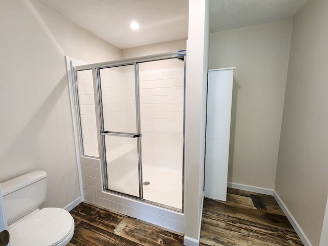 2521 Bonnie Mae Rd, Harrison, MI 48625 - full bathroom with wood finished floors, toilet, a shower stall, and baseboards