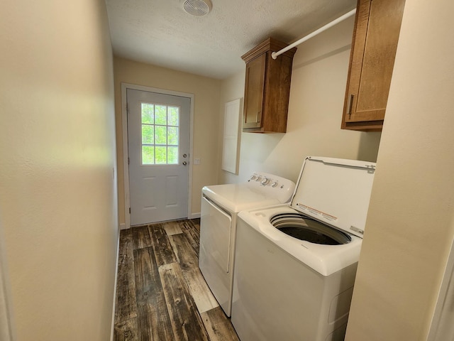 2521 Bonnie Mae Rd, Harrison, MI 48625 - laundry area featuring washing machine and dryer, cabinet space, dark wood finished floors, and a textured ceiling