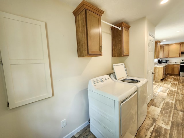 2521 Bonnie Mae Rd, Harrison, MI 48625 - laundry room featuring washing machine and dryer, cabinet space, light wood finished floors, recessed lighting, and baseboards