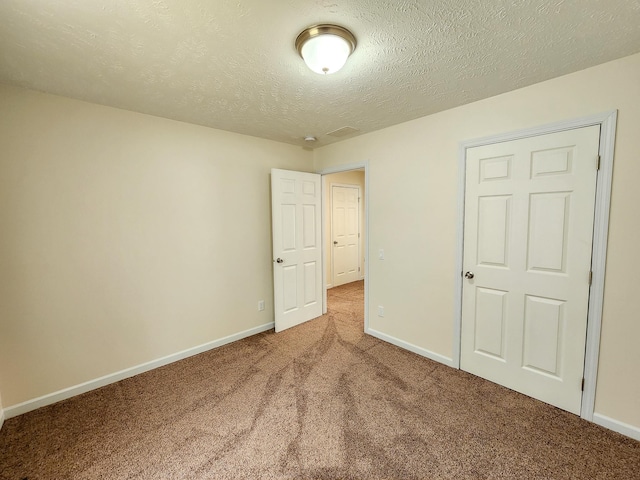 2521 Bonnie Mae Rd, Harrison, MI 48625 - unfurnished bedroom featuring carpet floors, baseboards, and a textured ceiling
