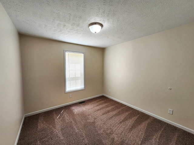 2521 Bonnie Mae Rd, Harrison, MI 48625 - unfurnished room featuring dark carpet, baseboards, and a textured ceiling