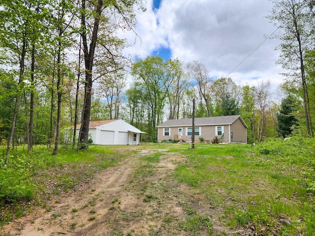2521 Bonnie Mae Rd, Harrison, MI 48625 - view of yard featuring an outdoor structure, a detached garage, and dirt driveway